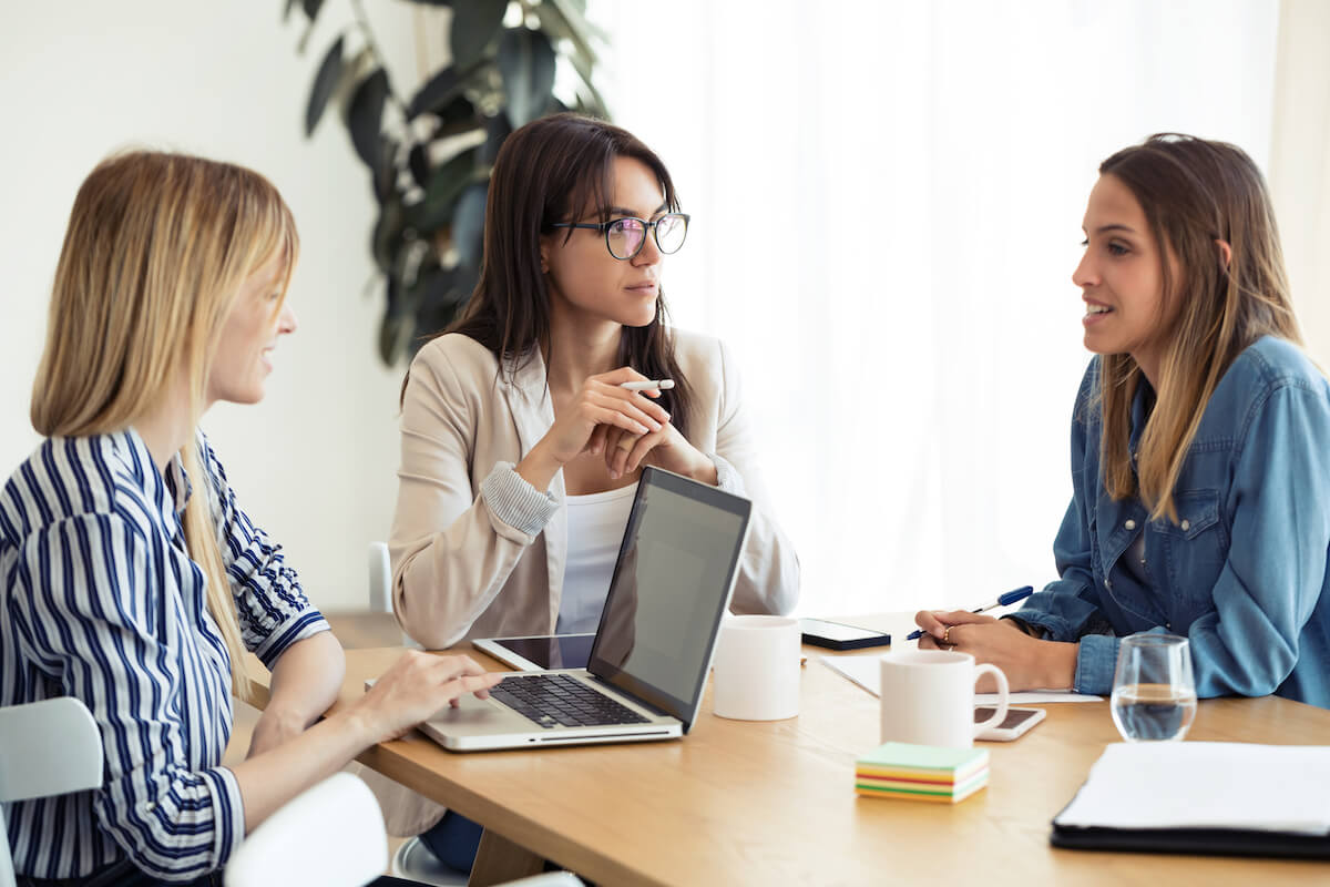 A professional man and woman having a serious discussion in an office setting, symbolising the nature of employment disputes and their causes in the UK, relevant for Locate Solicitors.